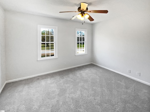 spare room with carpet floors, baseboards, and ceiling fan