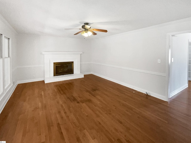 unfurnished living room with wood finished floors, baseboards, a fireplace, and ceiling fan