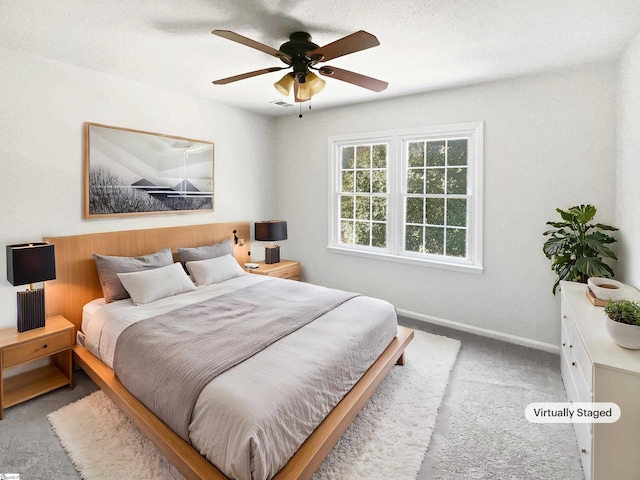 carpeted bedroom with baseboards, ceiling fan, and visible vents