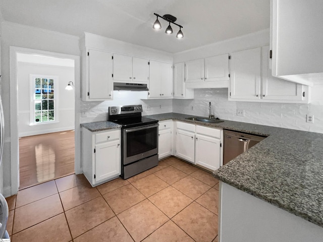 kitchen with light tile patterned floors, under cabinet range hood, a sink, white cabinets, and appliances with stainless steel finishes