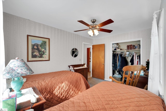 bedroom featuring wallpapered walls, a closet, and ceiling fan