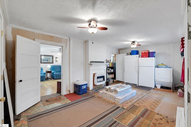 interior space with washer / clothes dryer, a textured ceiling, a ceiling fan, and freestanding refrigerator