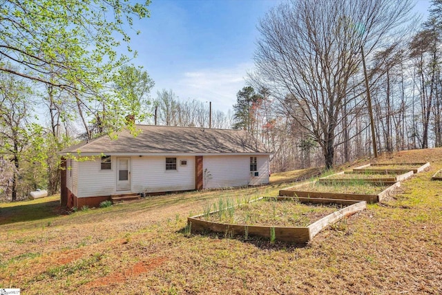 view of yard with a garden and entry steps