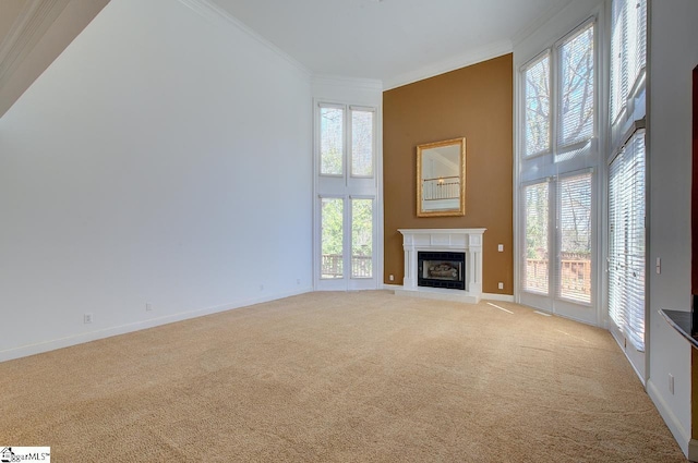 206 Chelsea Ln, Greer, SC 29650 - unfurnished living room with light colored carpet, ornamental molding, a fireplace with raised hearth, baseboards, and a towering ceiling