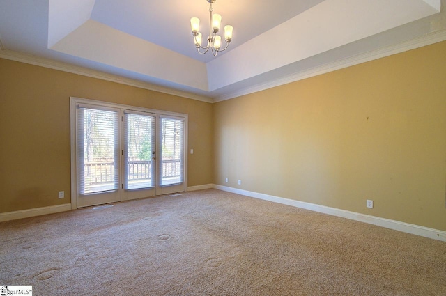 206 Chelsea Ln, Greer, SC 29650 - spare room featuring crown molding, baseboards, a raised ceiling, a notable chandelier, and light colored carpet