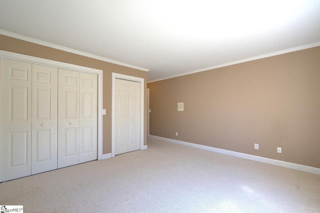 206 Chelsea Ln, Greer, SC 29650 - unfurnished bedroom with two closets, ornamental molding, baseboards, and light colored carpet