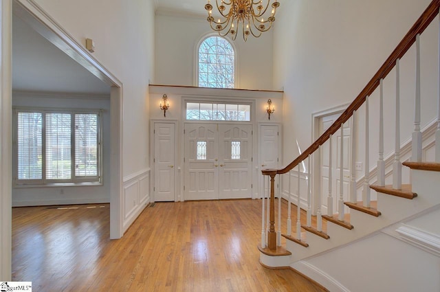 206 Chelsea Ln, Greer, SC 29650 - foyer entrance featuring stairs, a wealth of natural light, an inviting chandelier, and light wood-type flooring