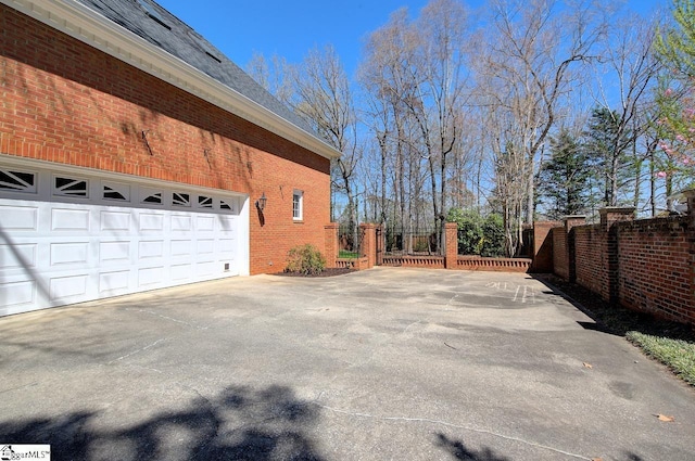 206 Chelsea Ln, Greer, SC 29650 - view of side of home with brick siding, concrete driveway, and fence