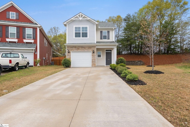 view of front of house featuring stone siding, fence, a garage, a front yard, and driveway