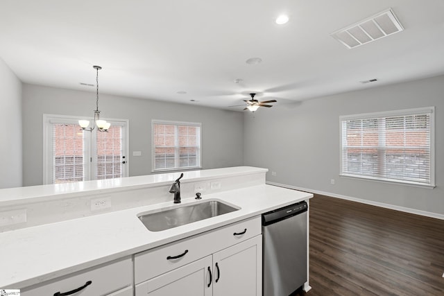 kitchen featuring white cabinets, visible vents, dishwasher, dark wood-type flooring, and a sink