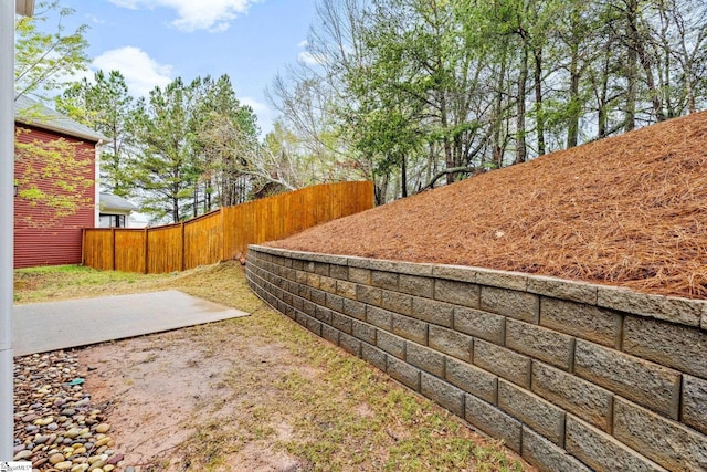 view of yard featuring fence and a patio area
