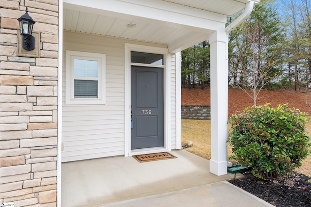 entrance to property with stone siding