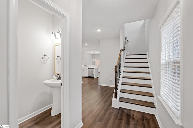 stairway featuring recessed lighting, baseboards, and wood finished floors