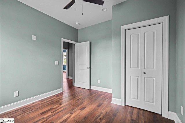 unfurnished bedroom with a ceiling fan, a closet, baseboards, and wood finished floors