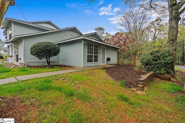 view of property exterior with a lawn