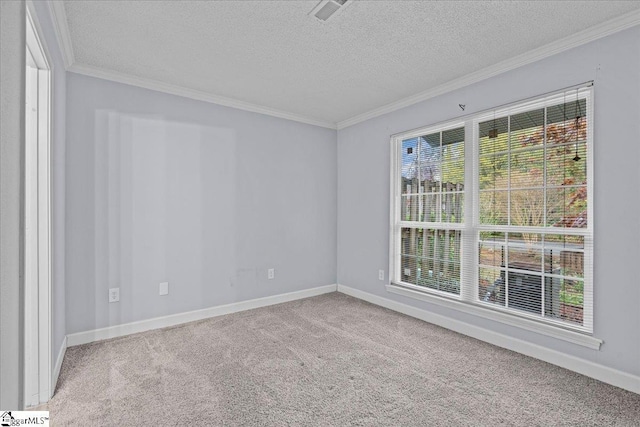 empty room featuring baseboards, crown molding, and carpet