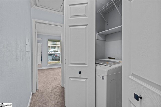 laundry room with crown molding, carpet floors, laundry area, washer / dryer, and a textured wall