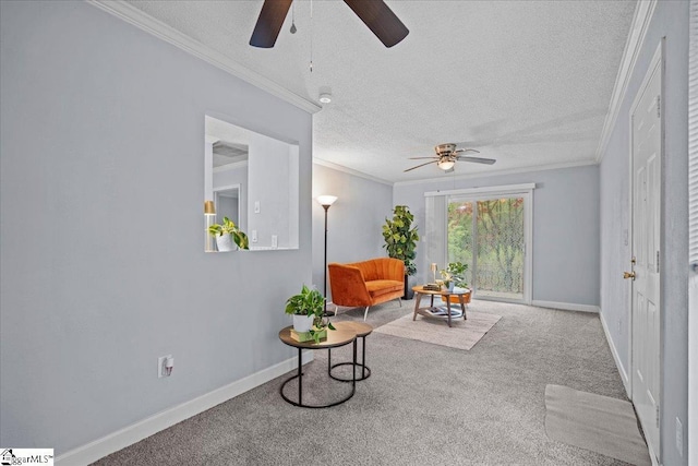 interior space with carpet flooring, a textured ceiling, crown molding, baseboards, and a ceiling fan