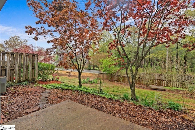view of yard featuring fence and a patio area