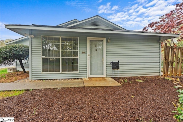 ranch-style home featuring fence