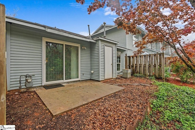 rear view of house featuring a patio, central AC unit, and fence