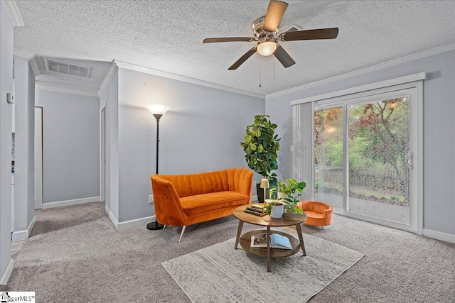 sitting room featuring visible vents, ornamental molding, carpet, and a textured ceiling