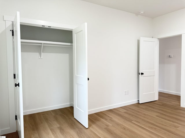 732 Corn Mill Rd, Cowpens, SC 29330 - unfurnished bedroom with light wood-type flooring, a closet, and baseboards