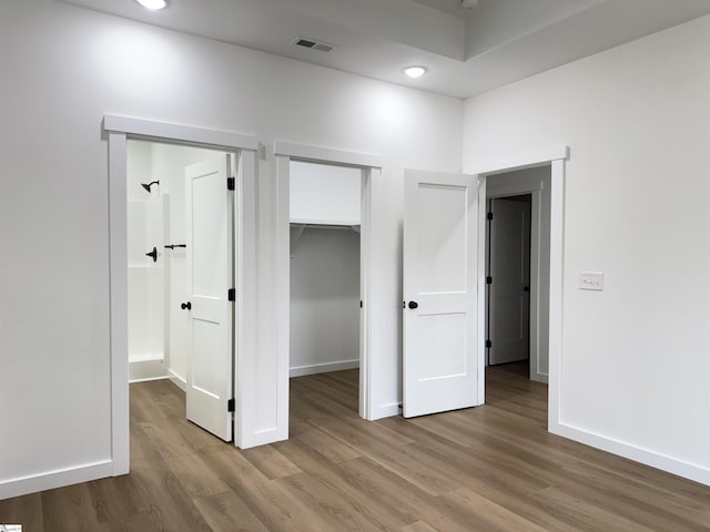 732 Corn Mill Rd, Cowpens, SC 29330 - unfurnished bedroom featuring wood finished floors, baseboards, a walk in closet, and a closet