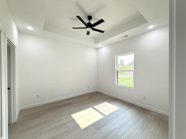 1221 Humphries Rd, Cowpens, SC 29330 - empty room featuring a tray ceiling, recessed lighting, light wood-style flooring, baseboards, and ceiling fan