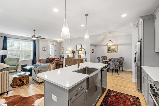 kitchen with crown molding, open floor plan, gray cabinets, and light countertops