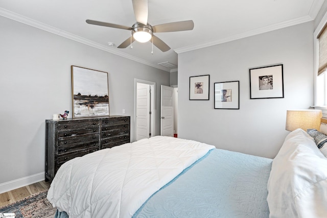 bedroom featuring baseboards, ornamental molding, wood finished floors, and ceiling fan