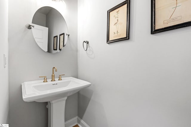 bathroom with baseboards and a sink