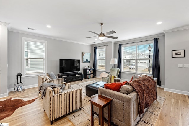 living area featuring baseboards, visible vents, crown molding, and light wood-style flooring