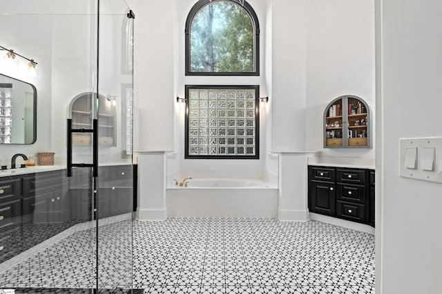 3 Bailey Knoll Ct, Simpsonville, SC 29681 - bathroom featuring a shower stall, a high ceiling, vanity, and a garden tub