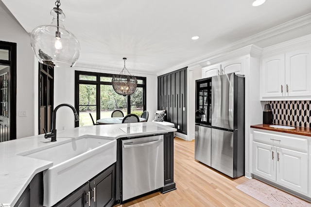 3 Bailey Knoll Ct, Simpsonville, SC 29681 - kitchen featuring appliances with stainless steel finishes, white cabinetry, a sink, decorative light fixtures, and light wood-style floors