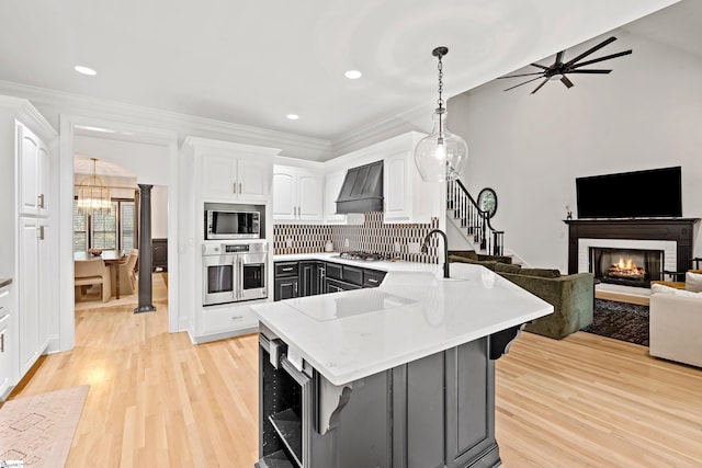 3 Bailey Knoll Ct, Simpsonville, SC 29681 - kitchen with premium range hood, a sink, white cabinets, a peninsula, and appliances with stainless steel finishes