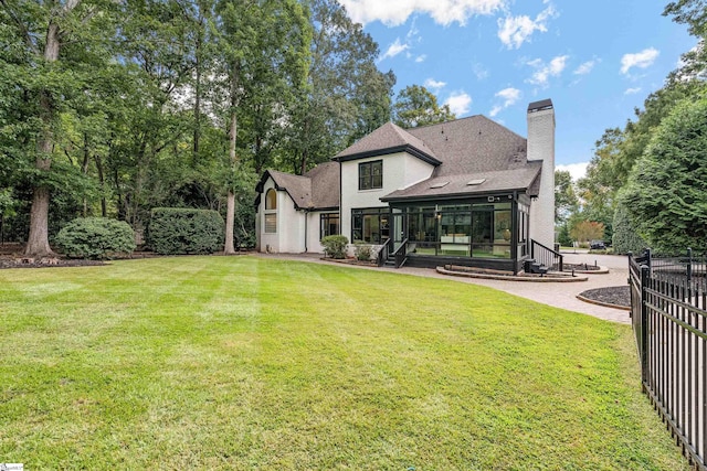 3 Bailey Knoll Ct, Simpsonville, SC 29681 - back of property with a chimney, a sunroom, fence, and a lawn