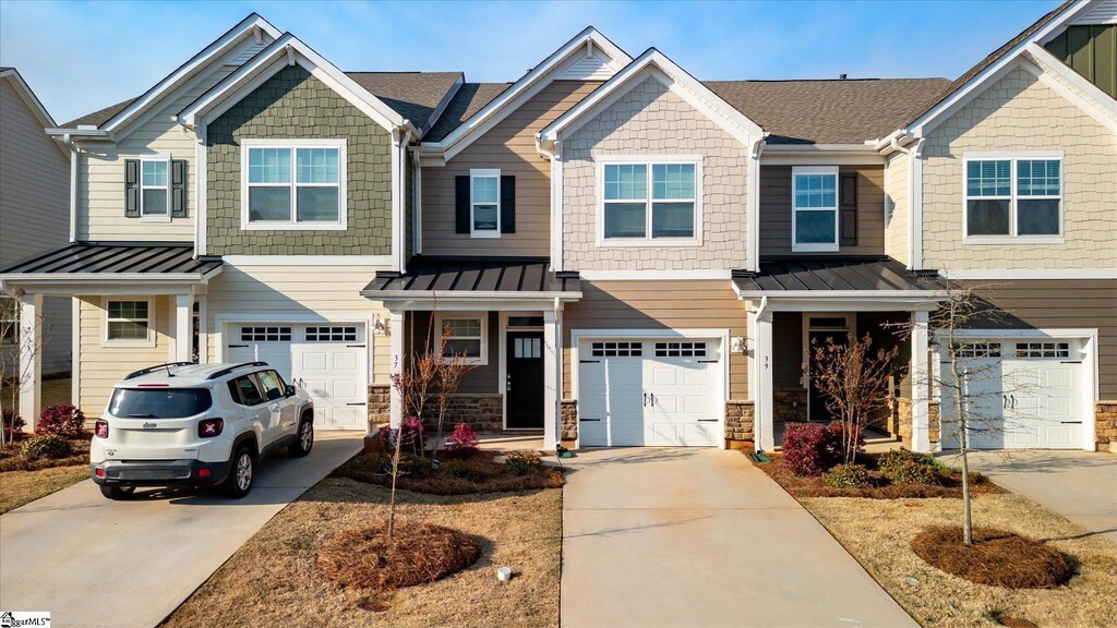 37 Gaskins Trl, Travelers Rest, SC 29690 - view of front of home featuring metal roof, a garage, and a standing seam roof