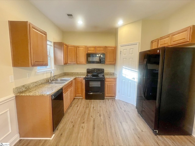 410 Airdale Ln, Simpsonville, SC 29680 - kitchen with visible vents, light brown cabinets, a sink, light wood-style floors, and black appliances