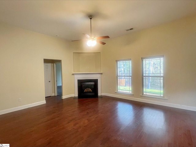 410 Airdale Ln, Simpsonville, SC 29680 - unfurnished living room with baseboards, dark wood-style floors, visible vents, and a fireplace with flush hearth