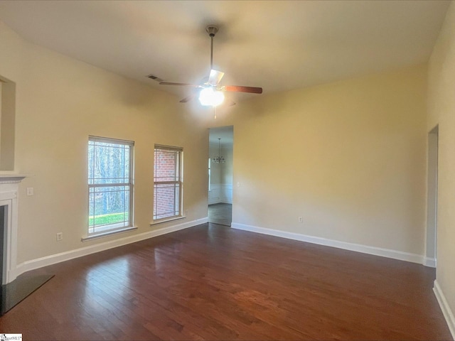 410 Airdale Ln, Simpsonville, SC 29680 - unfurnished living room with baseboards, dark wood-style floors, a ceiling fan, and a fireplace with raised hearth