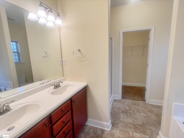 410 Airdale Ln, Simpsonville, SC 29680 - bathroom with double vanity, a sink, and a walk in closet