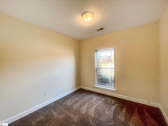 410 Airdale Ln, Simpsonville, SC 29680 - spare room with baseboards, visible vents, and dark carpet