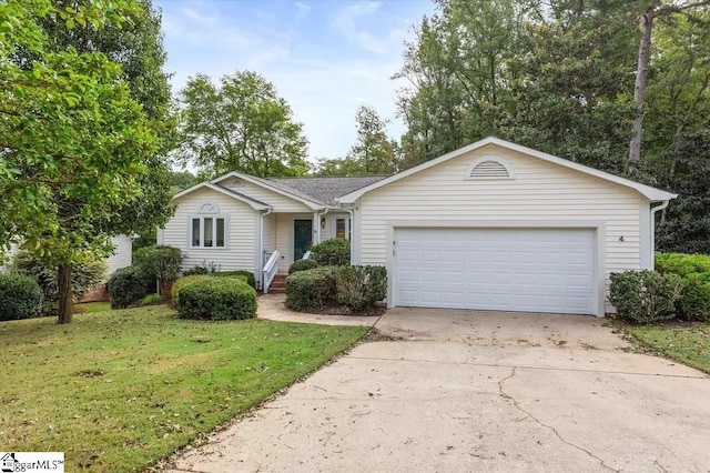 ranch-style home with a shingled roof, a front yard, an attached garage, and concrete driveway