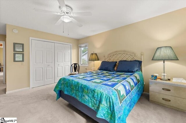 bedroom featuring a closet, a ceiling fan, baseboards, and carpet