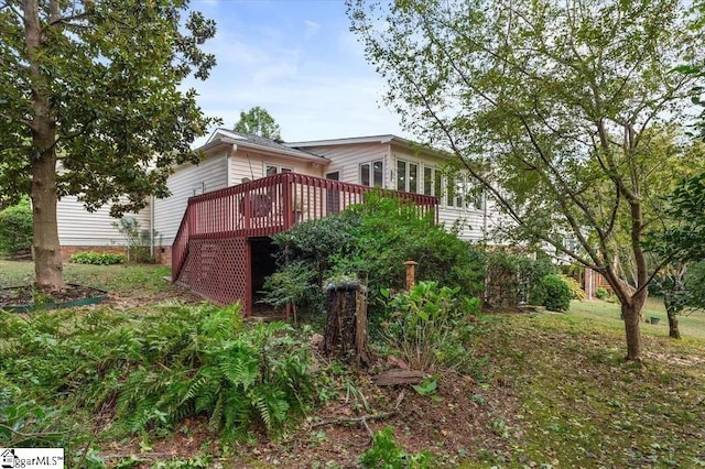 view of side of home with a deck