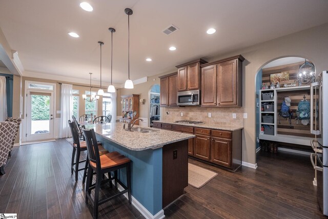 313 Rosendale Way, Simpsonville, SC 29681 - kitchen with light stone counters, visible vents, appliances with stainless steel finishes, arched walkways, and a sink