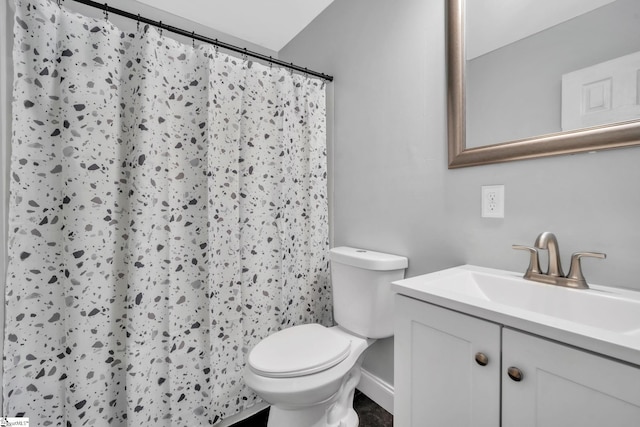 bathroom with a shower with shower curtain, toilet, and vanity