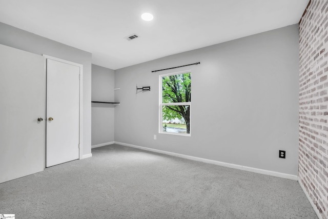unfurnished bedroom with baseboards, carpet floors, and visible vents