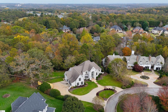 drone / aerial view featuring a residential view and a forest view